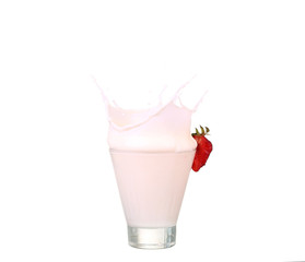 splashing strawberry into a milk glass