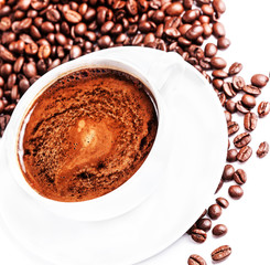 Coffee cup and saucer with roasted coffee beans isolated on a wh