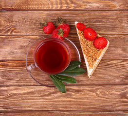 sweet cake with cup of tea on wooden table