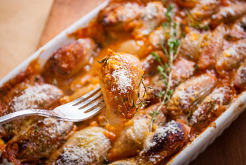 Baked onions stuffed with feta cheese and tomatoes