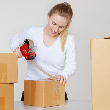 Woman wraps up a packet for delivery