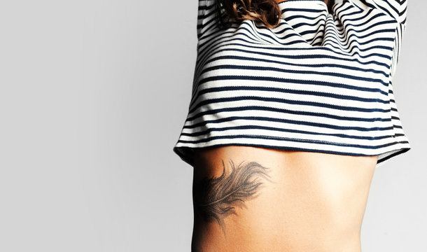 Tattoo. Close-up portrait of a Young girl wearing stripped t-shi
