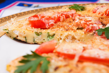 Omelet with cauliflower, tomatoes, fresh herbs and cheese 