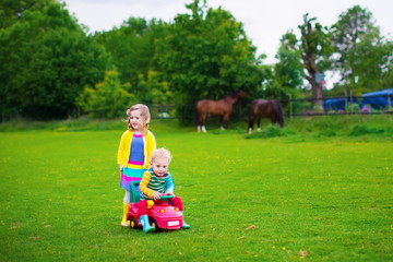 Kids on a farm with horses