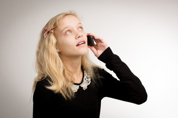 Teenage Girl Talking On Her Phone Looking Up