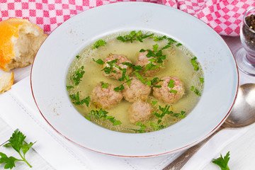 Meatballs in broth with parsley