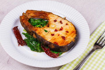 Broiled fish with dried tomatoes and spinach