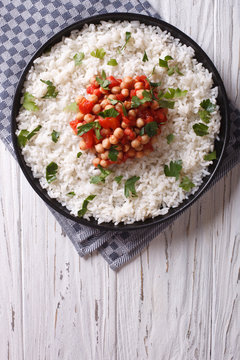 Rice with chickpea on the plate. vertical top view
