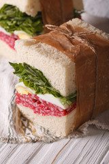homemade sandwiches wrapped in paper vertical macro

