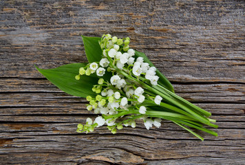 lilly of the valley on wooden surface