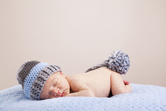 Newborn Baby Sleeping On Blue Blanket