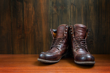 Vintage military boots on wooden background