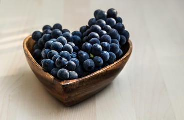 Grapes in a heart shape wooden plate