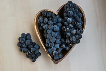 Grapes in a heart shape wooden plate