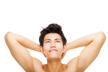 Obraz premium Handsome smiling young man looking up