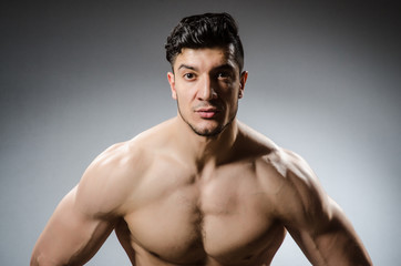 Fototapeta premium Muscular man posing in dark studio