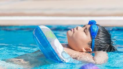 fat boy sleeping on water in swimming pool.