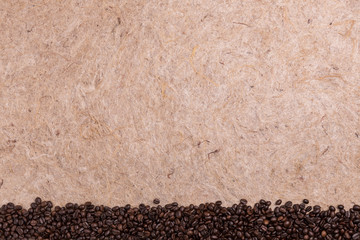 mulberry paper texture with coffee bean on top and copy space