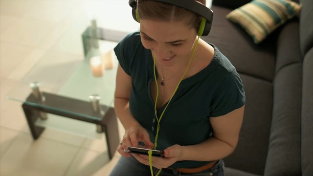 Woman Listening Music Podcast On Phone With Earphones