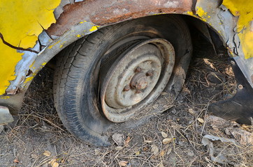 Fototapeta na wymiar Detail Shot of a Flat Tire on a Car Selection Focus on Tire