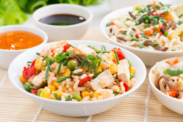 Asian food - fried rice with tofu, noodles with vegetables 