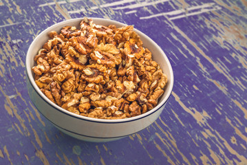 Walnuts in Bowl on Rustic Wooden Background