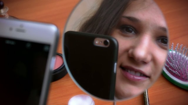 Selfie. Young beautiful woman making self portrait with a phone