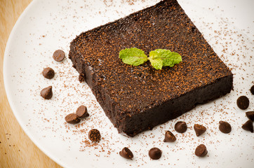 Homemade brownie with chocolate chip on white plate