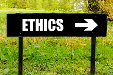 ETHICS written on directional black metal sign