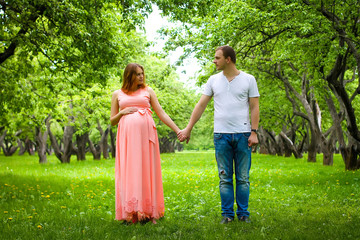 Fototapeta premium Pregnant woman with man at park