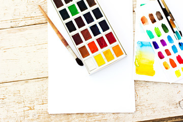 Workplace artist - paper, paint, brushes, color wheel