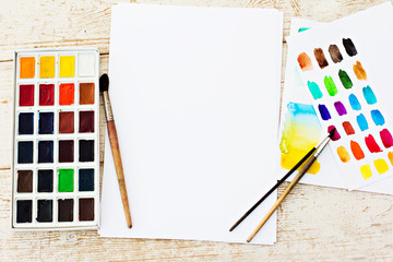 Workplace artist - paper, paint, brushes, color wheel