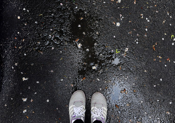 sneakers on wet asphalt