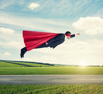 man dressed as a superhero flying