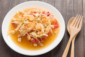 Papaya salad thai food on wooden background