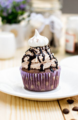 Chocolate Cupcake with chocolate frosting on the table