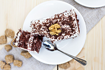 Delicious chocolate cake on plate on table on light background