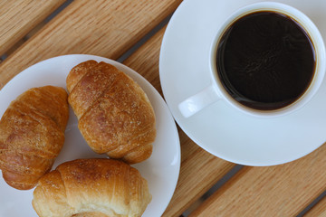 aromatic coffee and croissants on a plate