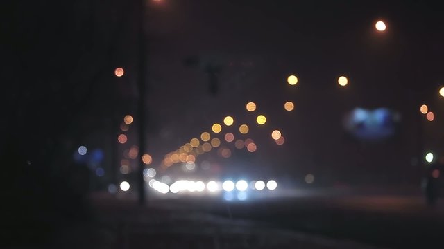 Rain defocused night traffic in city