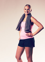 Fototapeta premium Woman posing with hand on hip wearing workout clothes.