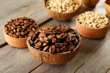 Various of coffee in small dishes on wooden table, closeup