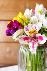 Beautiful spring flowers on wooden background