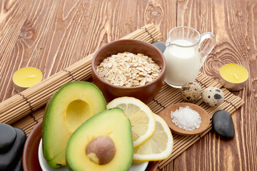 Fresh avocado on cutting board over wooden background