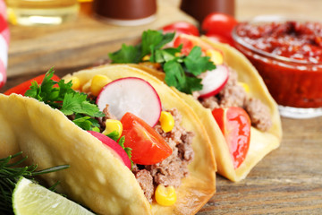 Mexican food Tacos on wooden table, closeup