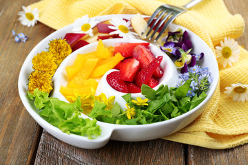 Light organic salad with flowers, close up