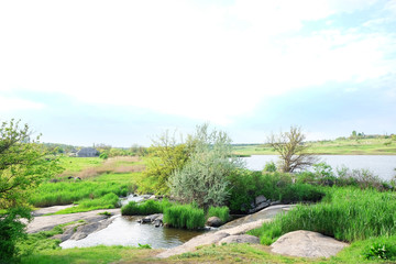 Fototapeta na wymiar Beautiful view of countryside with ponds on blue sky background