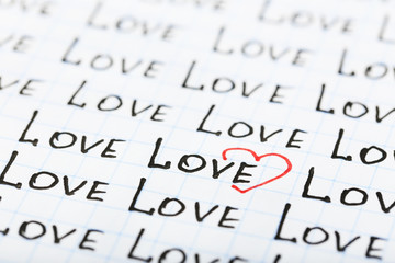 Words LOVE written on sheet of paper background