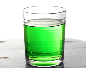 Glass of water with bubbles on table close up