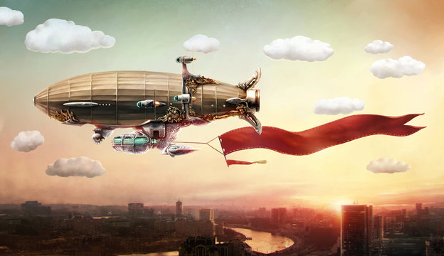 Dirigible with a banner, in the sky over a city.