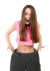Young slim woman wearing too big pats isolated on white